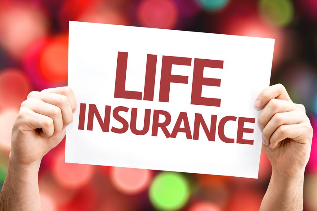 A person holding up a sign that says life insurance.
