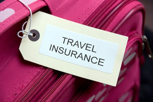 travel-insurance A pink suitcase with the words travel insurance on it.